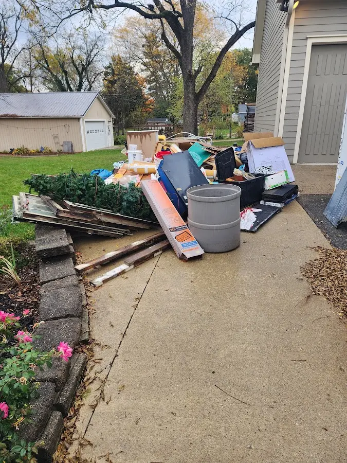 Dumpster being loaded with debris for Estate Cleanout Dumpster Rental in Ponchatoula